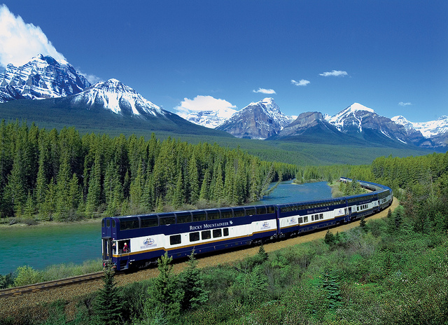 The Rocky Mountaineer thundering through the magnificent pine forests of Canada.